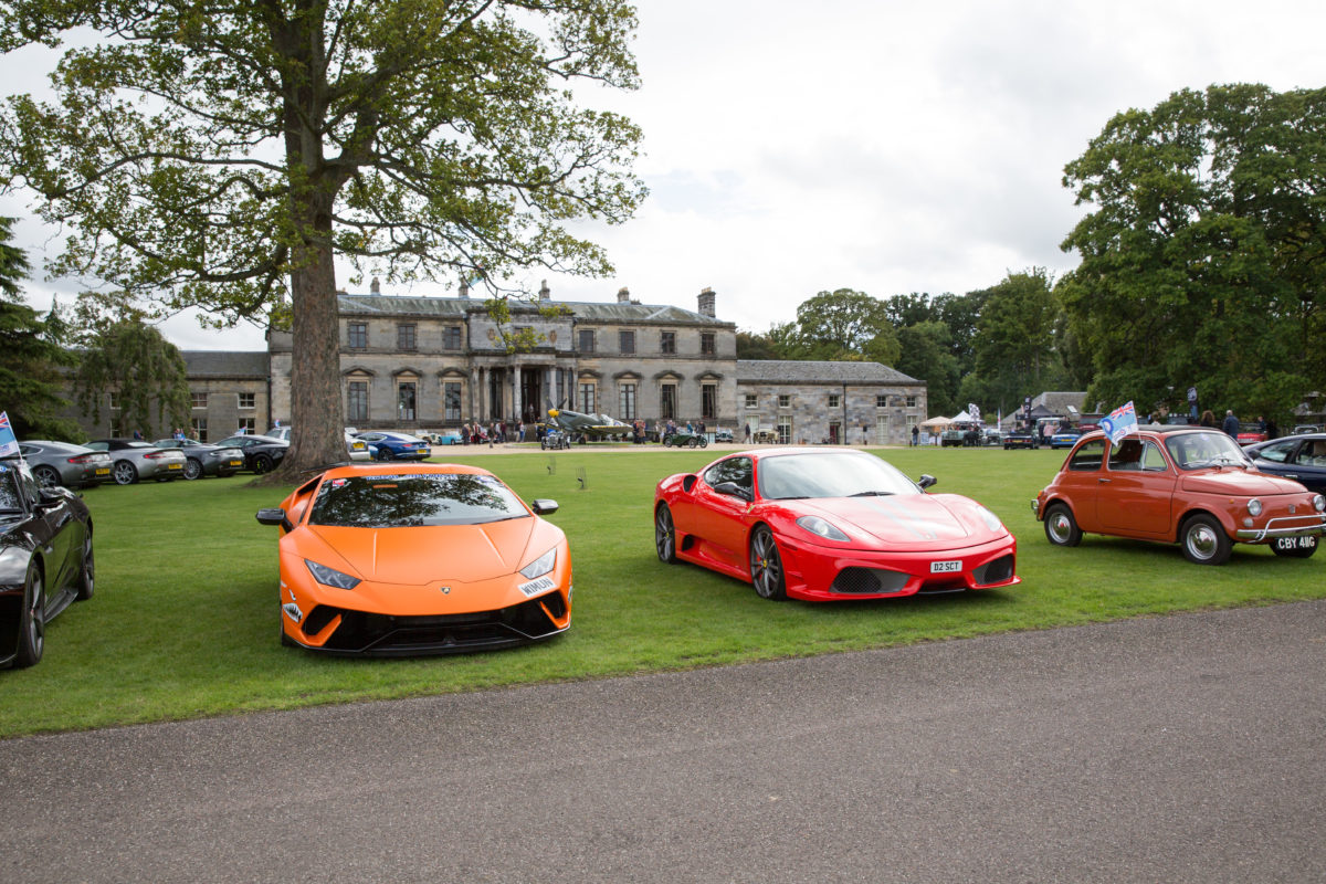 supercars in front of country estate