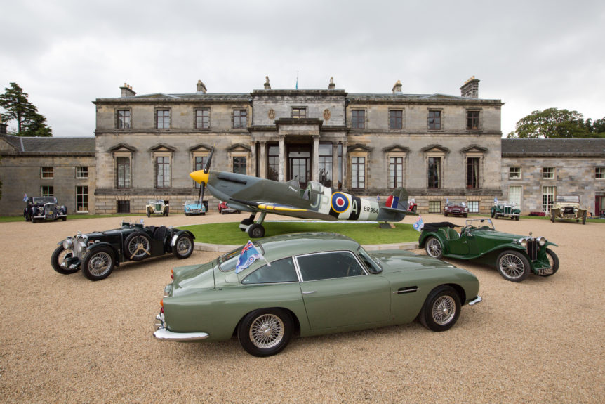 classic cars and spitfire in front of country estate
